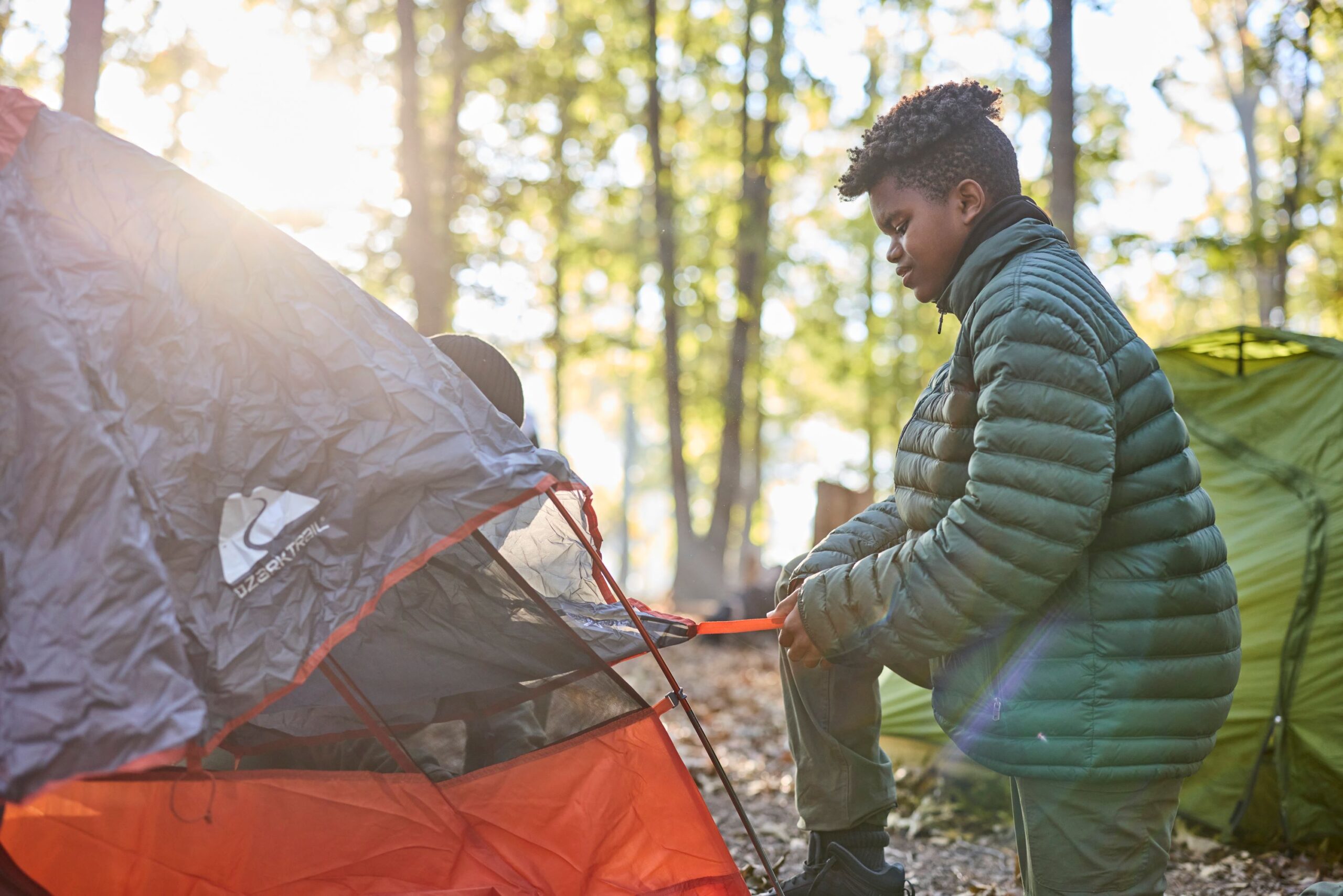Scout setting up tent